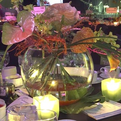 Low clear bowls with tropical blooms served as centerpieces on some of the tables.