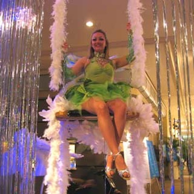 Models in fairy costumes from Champagne Show Girls sat on swings suspended from the ceiling above the Carlu's main entrance.
