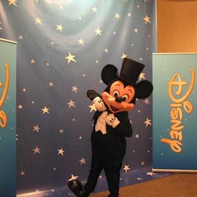 Mickey Mouse posed in front of a starry backdrop.