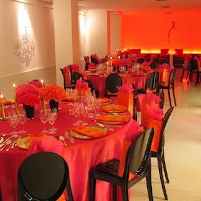 Black Louis Ghost chairs contrasted with an eye-popping fuchsia, orange, and red colour palette at Holt's Caf? in Holt Renfrew.