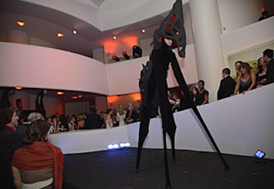 Stilt walkers in insect-like costumes paraded through the atrium, interacting with guests.