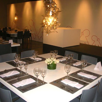 This stage-fronting table featured a white tulip centerpiece, a brownish chandelier, crystal ware, and enough room to sit eight people comfortably.