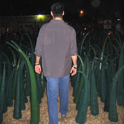 Guests entered the event through tall blades of plastic grass.