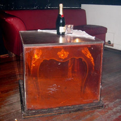 Mod acrylic cubes that housed antique-looking side tables added to the fabulous environment created inside.