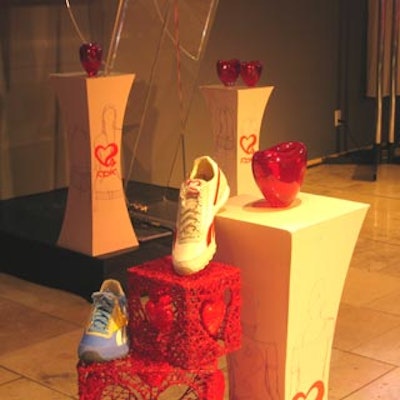 Shoes and a red heart decorated three pedestals near the stage.