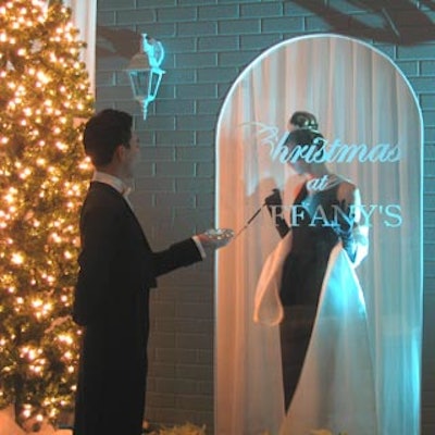 An Audrey Hepburn look-alike stood gazing at a diamond in a jewelry store window vignette during CTV's staff holiday party at Showline Studios.