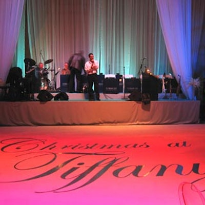 Christmas at Tiffany's was painted in elegant cursive on the dance floor in front of the dinner stage.