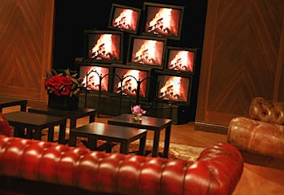 Leather couches sat in front of a crackling faux fireplace made of TV monitors.