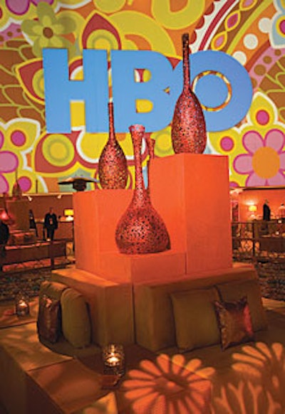 A mod floral design projected in intense shades of purple and kiwi served as a backdrop for the HBO logo that stretched across the wall overlooking the pool.