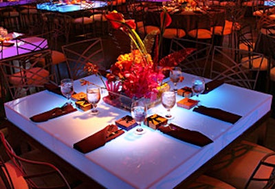 Feathers and corkscrew streamers accented centerpieces of brightly colored tulips, roses, hydrangeas, and calla lilies.
