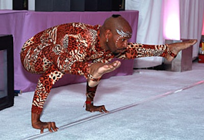 A contortionist demonstrated his flexibility for guests as they entered Hangar 8.