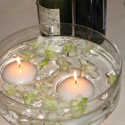 Centrepieces featured floating white orchids and candles.