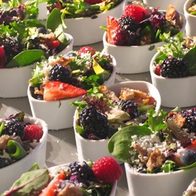 A winter-themed buffet station included colourful berry, vegetable, and cheese salads.