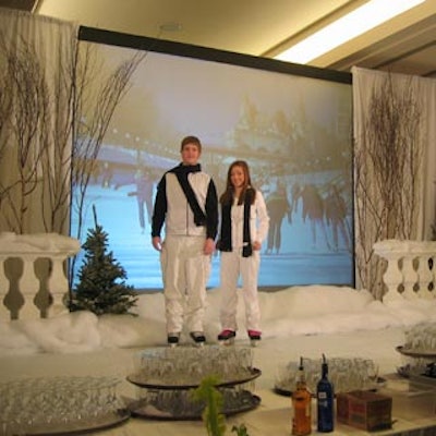 Ice Skaters from Cuthbertson Entertainment performed in the corridor on an artificial ice surface in front of a screen showing skaters on an a natural ice surface.