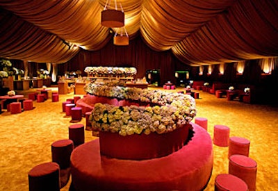 Hydrangeas filled vases throughout the tent and formed a hedge atop an S-shaped couch.