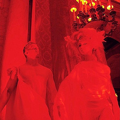 Live human statues lit in red lined the New York Public Library's Astor Hall.