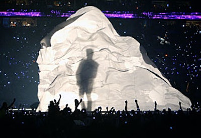 Light projected onto a large fabric screen cast a giant-sized Prince silhouette during the half-time performance.