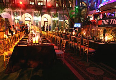 For Shaq's 'Super 60' dinner, Berger draped two long tables in layered black silk linens, accented by Chiavari chairs. Tall glass hurricanes lined the tables, along with frosted-glass votives and potted white orchids.