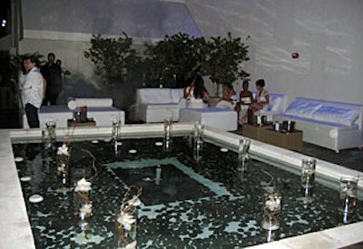 Floating candles and orchids in glass cylinders set an ethereal vibe at the heaven-themed Bauer's Pure Rush event.