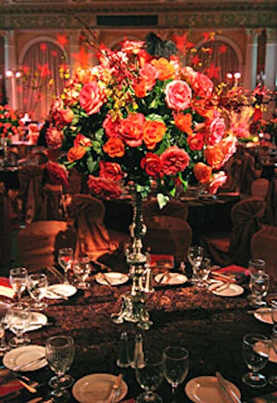 Clouds of roses in tall, silver-colored vases topped the dining tables.