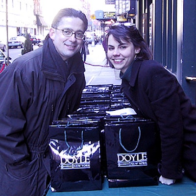 Louis LeB. Webre, vice president of marketing for Doyle New York, and ASPCA's Mary Van Pelt guarded the food-packed giftbags.