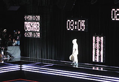 Similar to last season’s presentation, the runway had a built-in conveyor belt, this time in black to match the flooring.