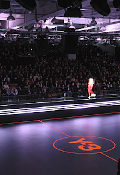 The Y-3 logo was painted, in blacklight paint, onto a temporary floor covering the court. LED technology enabled the production team to change the color of the runway.