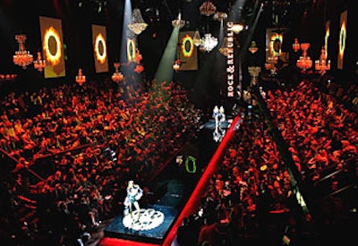 A runway made of smoked, mirrored plexiglass was elevated 18 inches off the ground. To create the effect of a floating runway, Stoelt Productions placed illuminated pixel strips under it. The Rock & Republic logo that models traipsed over was lit from below and changed color throughout the show.