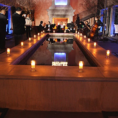 Votive candles in holders emblazoned with the Entertainment Weekly logo topped the ledge around the patio pool.