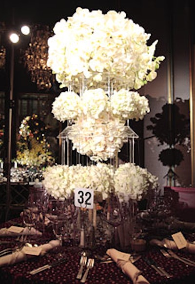 Amanda Nisbet Design stuffed orchids in a towering Lucite pagoda, which had glittery candles within the base.
