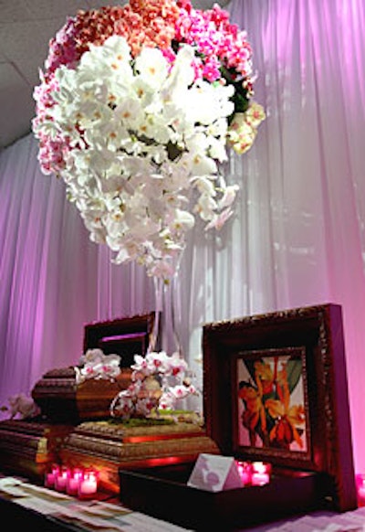 Guests arriving at the gala found their place cards on David Beahm’s entry table. Beahm used sponsor Larson Juhl’s golden frames as vases and worked in the company’s framed mirrors and new Artaissance line of orchid prints.