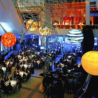 Glowing spheres hung over silver-clothed tables.