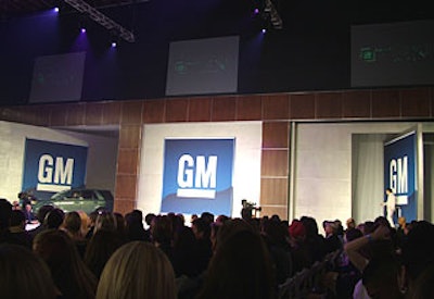 GM-logoed doors swiveled open to reveal cars and their celebrity escorts.