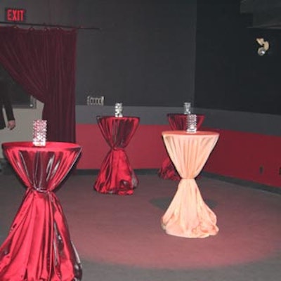 Colourful satin linens from Have-A-Seat covered simple cocktail tables.