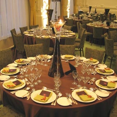 MCC Planners used tall, green glass vases, able to stand right-side up or upside down, as centerpieces.