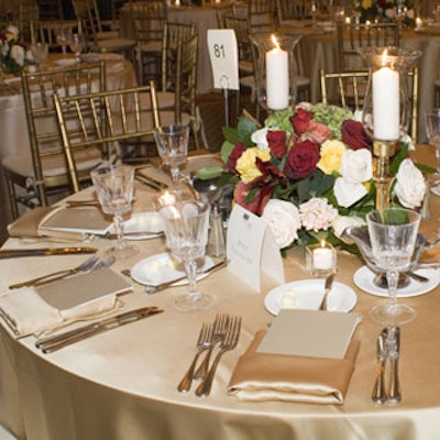 The decor all matched—from PKS Rentals' gold Chiavari chairs to the SHOWORKS-provided gold satin napkins and gold and hunter green satin floor-length linens.