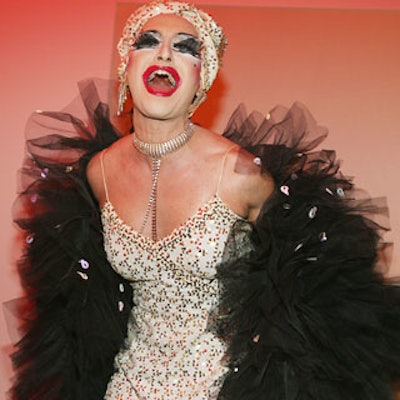 Sporting a white cocktail dress and some black fur, famed drag queen Adora drew more than her share of stares as she performed songs like 'Diamonds Are Forever' for guests.