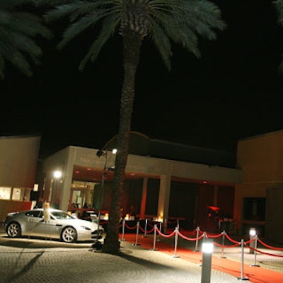 The MOCA entrance featured a red carpet in the middle, a platinum British sports car to the left, and the POP 007 red, white, and black logo projected onto the wall on the right.