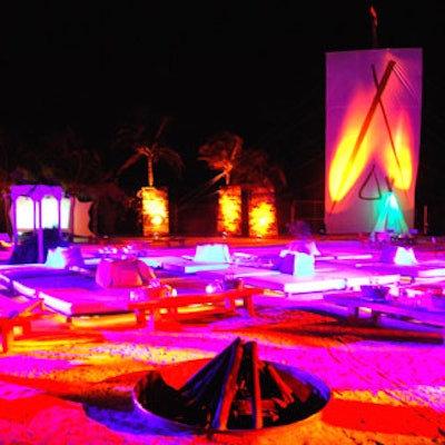 The Nikki Beach celebration spilled over onto the beach, where the furniture was spread out and a lot of torches were lit under a giant banner.