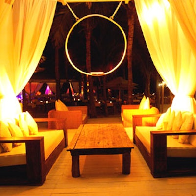 White-clothed wooden furniture provided comfortable seating for guests at the various Nikki Beach cabanas.