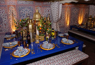 Elle Decor editor in chief Margaret Russell found inspiration in Arabic motifs this year, creating a dining area reminiscent of a tented bazaar. Russell used yards of patterned fabric from Iksel to create tenting and tufted cushions for the low benches that surrounded each of the four cobalt-blue tables. A variety of colorful Moroccan lanterns and miniature orange trees grouped in the middle of each table made exotic centerpieces.