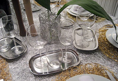 Throughout the event, designers paired drinking glasses in unusual combinations. We spotted a variety of purposely mismatched styles and vessels in different yet coordinating colors. Trios of glasses placed on miniature silver platters adorned each place setting at the Alessi table for The New York Times. The trays added an element of shine into Alessi's predominantly white, ethereal look, inspired by the clouds.