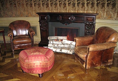 Guests more inclined to lounge found respite in the living room-like setting of aged leather club chairs and comfy fabric couches clustered around a faux fireplace on the perimeter of the room.