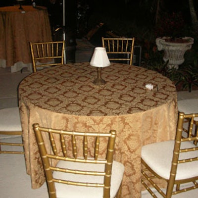 Cocktail tables were covered in fancy gold linens and topped with petite-sized lamps.