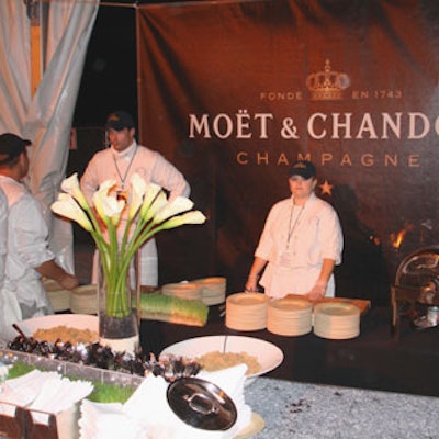Calla lilies arranged in tall cylindrical glass vases were found at many of the serving stations, as were black backdrops featuring the Moet & Chandon logo.