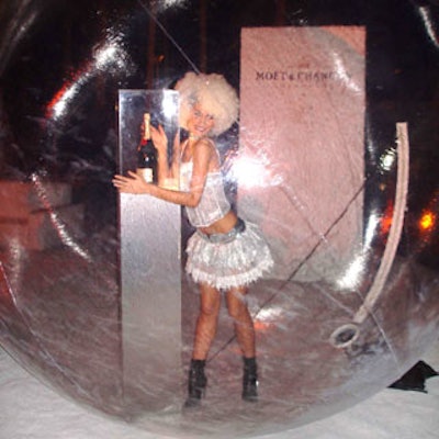 Perched inside a large plastic bubble, a model showed off her funky style while posing flirtatiously with a magnum of Moet & Chandon White Star.