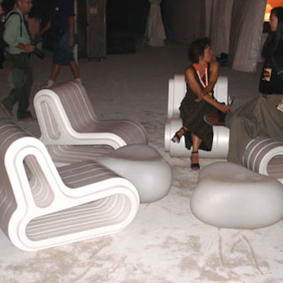 Ultra modern furniture, including Styrofoam chairs and low, molded plastic tables enabled guests to sit and relax.