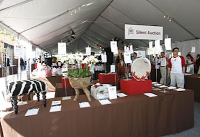 Guests circled silent auction tables at one end of the main tent and inside the store, which donated 25 percent of the day’s purchases to Stuart House.