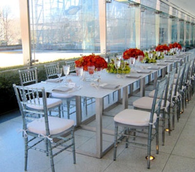 The setting from the North Galleria event space within the American Museum of Natural History. Party Rental Ltd. supplied dramatic, bright translucent tables and chairs, which mimicked the lines of the glass windows of the Rose Center, giving the impression that the setting floated in space.
