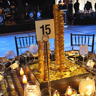 Some of the tables’ centerpieces featured precarious stacks of gold coins. To create them, Stark and his staff drilled holes into the foiled-wrapped chocolates and then used a rod to stabilize the pile.